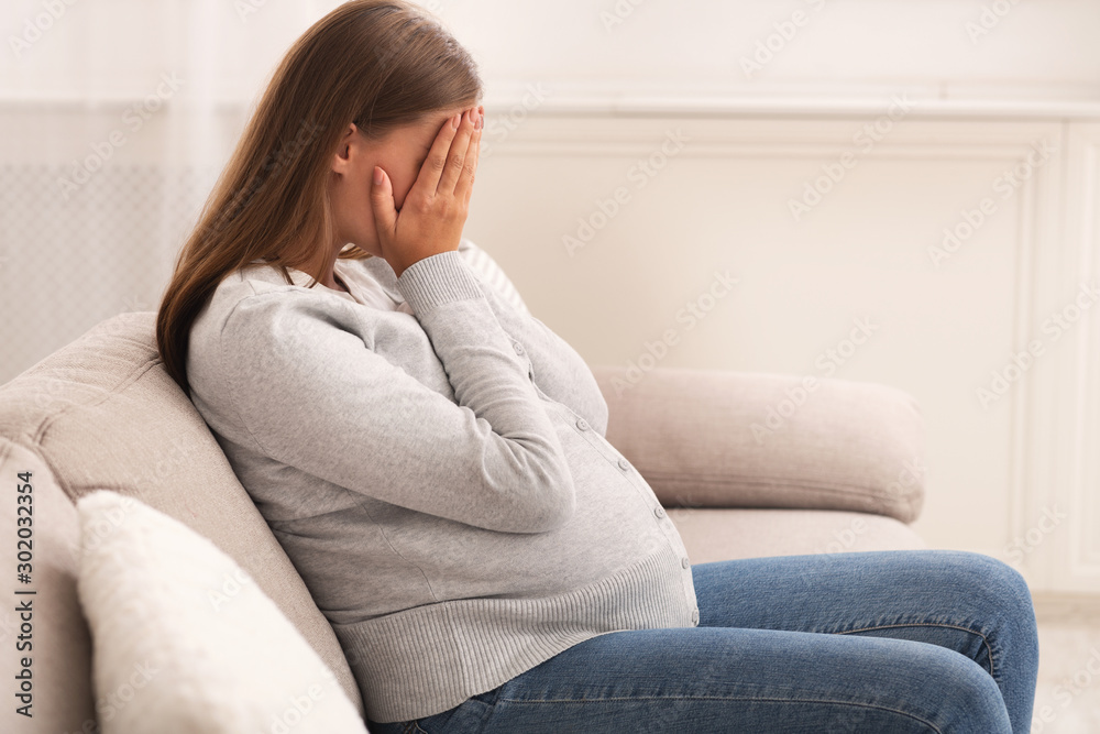 Pregnant Lady Crying Covering Face With Hands Sitting At Home Pregnant Lady Crying Covering Face With Hands Sitting At Home