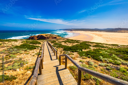 Praia da Bordeira and boardwalks forming part of the trail of tides or Pontal da Carrapateira walk in Portugal. Amazing view of the Praia da Bordeira in portuguese. Bordeira, Algarve, Portugal.