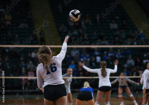 Фотография A young woman follows through on a serve