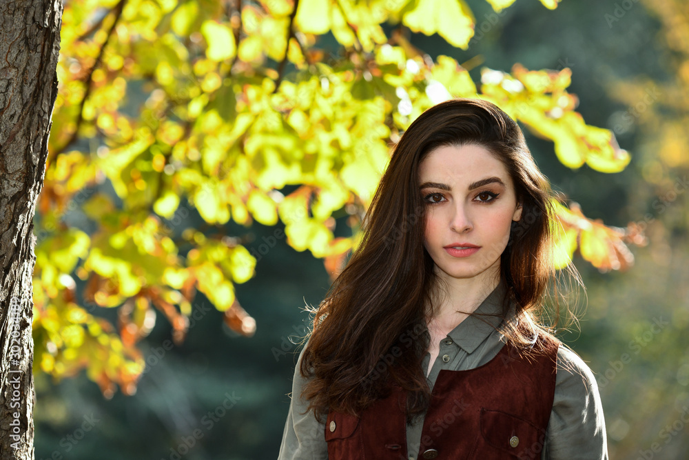 Portrait of beautiful young woman walking outdoors in autumn. Portrait of beautiful young woman walking outdoors in autumn.