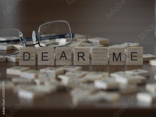 The concept of dear me represented by wooden letter tiles