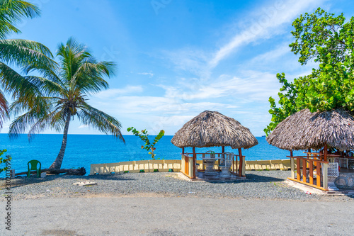 Tropical Scenic Views of the Ocean with Palm Trees and Huts from the Dominican Republic.
