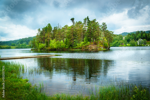 Jonsvatnet lake in Trondheim, Norway. Natural drinking water tank. View of the island and the bridge. photo