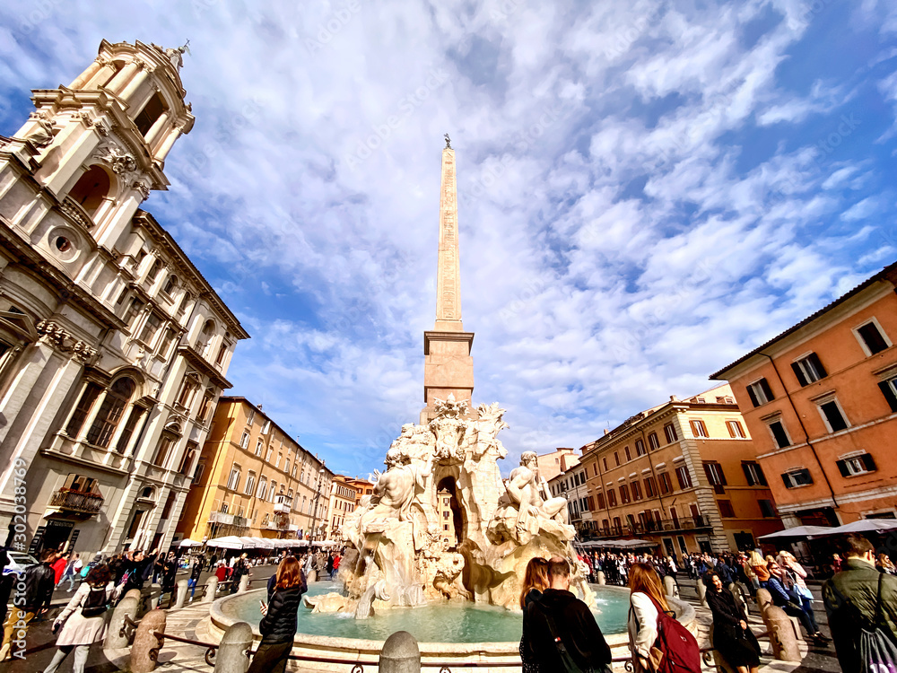 Vászonkép crowd of people enjoying a sunny autumn day walking near the famous fountain of the four rivers in the center of Piazza Navona in Rome