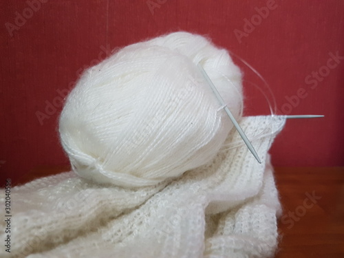Knitting clothes made of white wool.