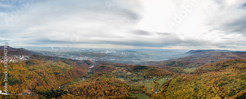 Autumn colorfull forest aerial panorama with factory