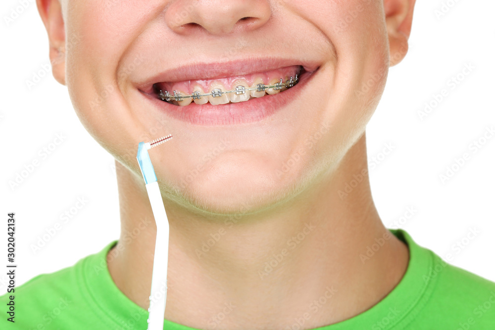 Naklejka premium Young man with toothbrush on white background