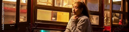 Asian girl who is glaring at the window glass at night