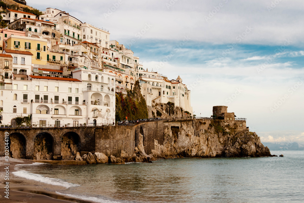 AMALFI, ITALY NOVEMBER 7 2019: Amalfi city view on houses, fortress and sea beach from the pier
