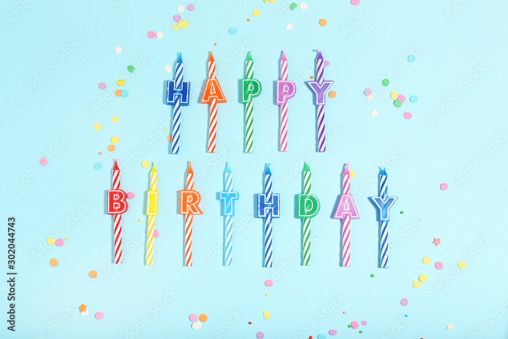 Candles with text Happy Birthday on blue background. Minimalism concept