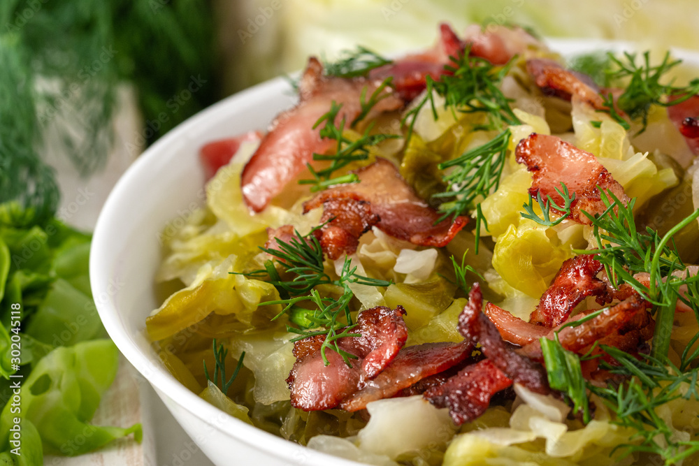 Stewed young cabbage with dill and grilled bacon. Stewed young cabbage with dill and grilled bacon.