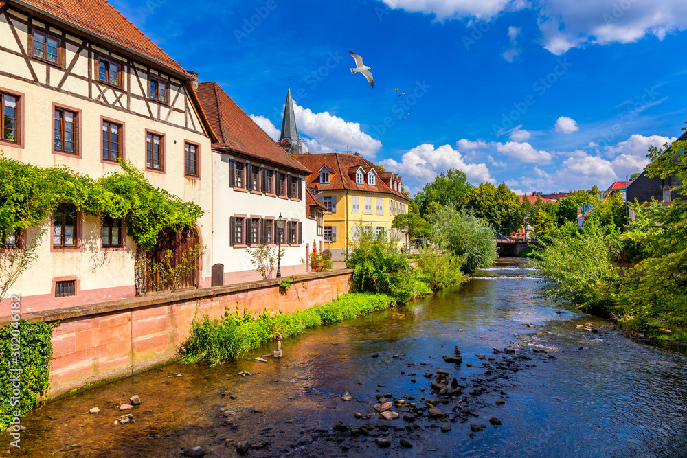 Old city of Ettlingen in Germany with a river and a church. View of a central district of Ettlingen, Germany, with a river and a bell tower of a church. Ettlingen, Baden Wurttemberg, Germany.