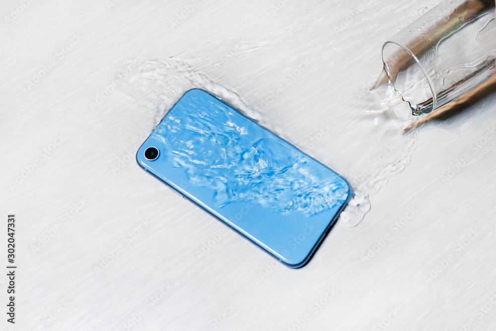 Wet blue smartphone in water on table, floor. Accident with cell mobile  phone, water flowing from spilled glass. Water resistant technology test,  waterproof. Damaged phone, need repairing. Careless. Stock-Foto | Adobe  Stock