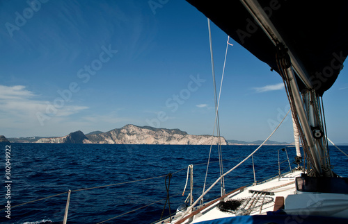 bow of sailboat with open genoba the city of ibiza in the background photo