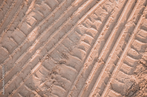 Sand surface/dirt road with wheel marks.