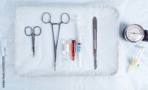 Surgical clamps, scalpel and syringe on the table