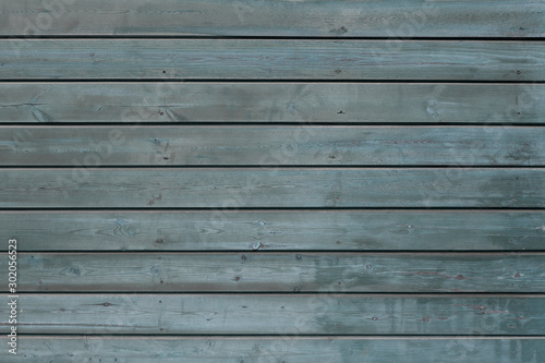 Texture blue wooden background. Background from several natural horizontal boards of blue color. The old painted.