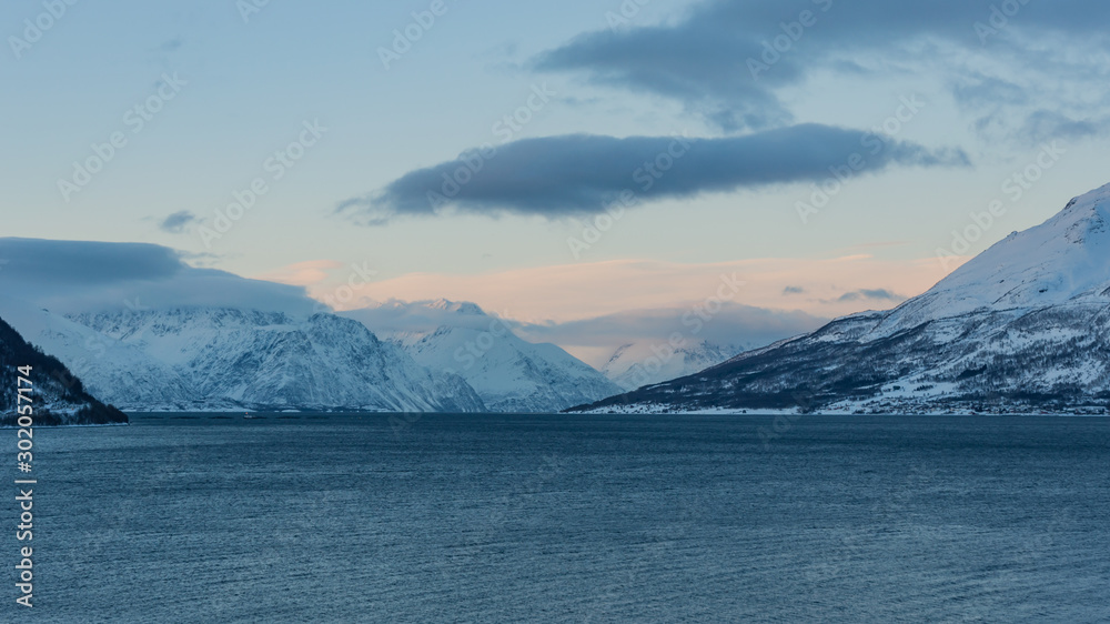 Snowy mountains by a fjord in northern Norway in winter