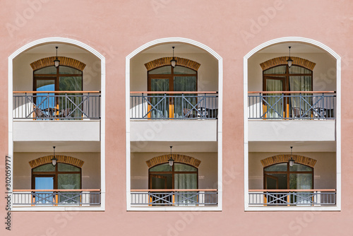 Windows and balconies of the new building at day time.