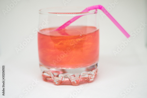 Wallpaper Mural Pink drink in a glass cup with a pink straw for cocktails isolated on white background Torontodigital.ca