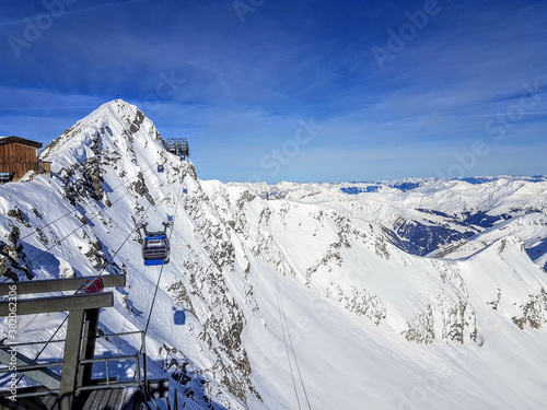 Photo of cableway among snowy hills