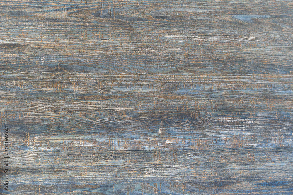 Naklejka premium Old wooden blue background. The texture of a scratched tree is one board. Traces of a cut of a tree with.