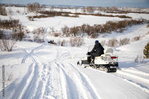 Rider on the snowmobile in nature of Siberia, Russia