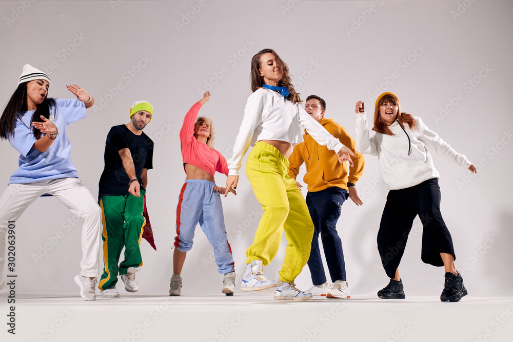 Cheerful young teenagers dressed in brightly lighted sportswear dancing  actively at hip hop party, gathered together, having cool time, feeling  free, human emotions, youth, love lifestyle concept Stock Photo | Adobe  Stock