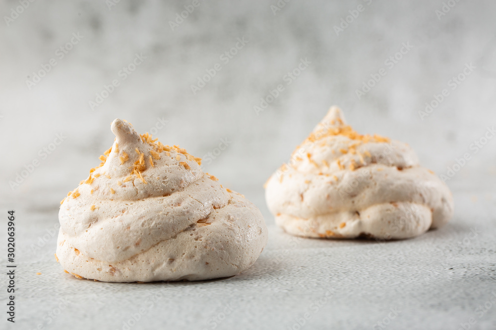 French meringue cookies, macro shot on bright marble background. Tray of meringues. Closeup meringue photo. Dessert background. Sweets. Food. Flat lay and copy space. Top view. Horizontal