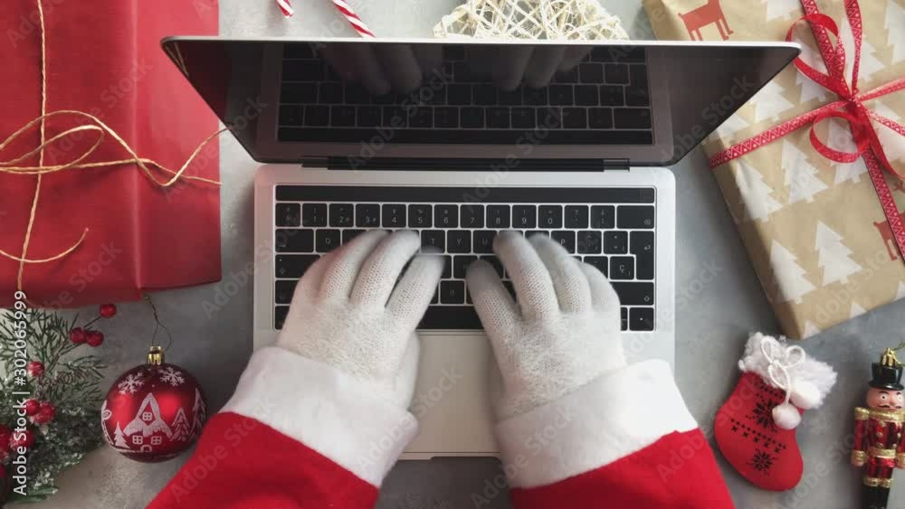 Top view of Santa typing on laptop