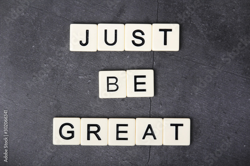 A motivational quote Just be great formed with tile letters 