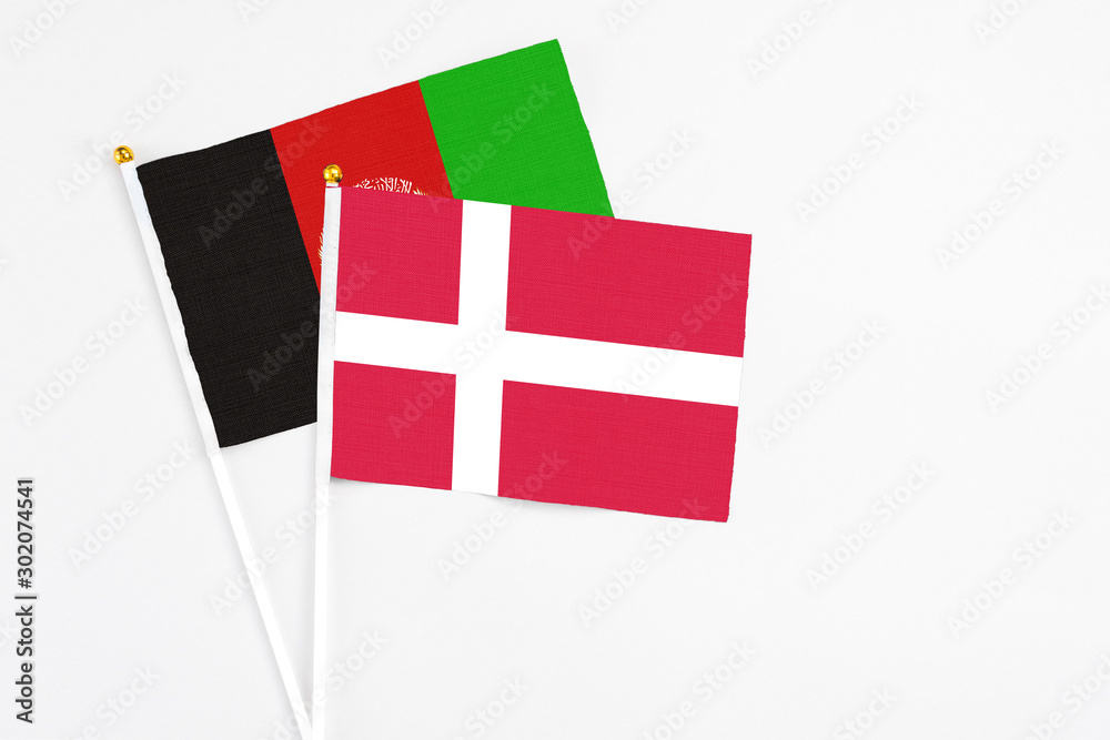 Denmark and Afghanistan stick flags on white background. High quality fabric, miniature national flag. Peaceful global concept.White floor for copy space.