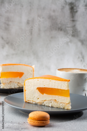 Obraz na płótnie Elegant Cake with coconut, passion fruit, mangoes and bananas, covered with chocolate glaze. Slice of orange layered cake on marble background. Wallpaper for pastry cafe or cafe menu. vertical. w salonie