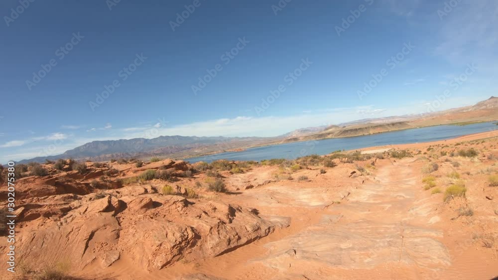 Off road 4x4 recreation extreme steep desert lake shore. Geologic landscape in southern Utah. Eroded into tall sandstone rocks, cliffs, sand dunes, and deep canyons. Off road 4x4 recreation extreme steep desert lake shore. Geologic landscape in southern Utah. Eroded into tall sandstone rocks, cliffs, sand dunes, and deep canyons.