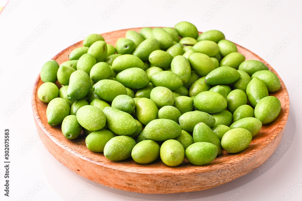 Fresh green olives with branches and leaves. Seasonal harvest in Italy. Top view. Fresh green olives with branches and leaves. Seasonal harvest in Italy. Top view.
