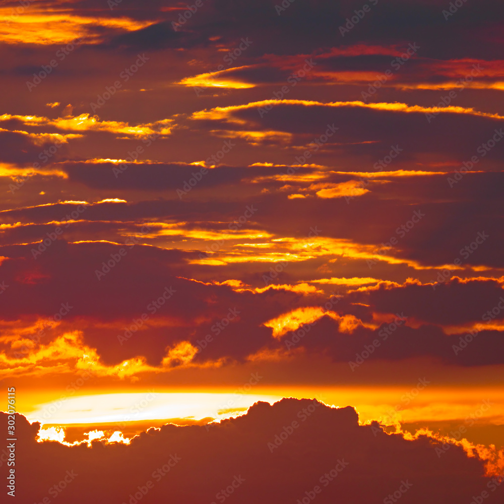Fototapeta premium Bright sun against background dark clouds