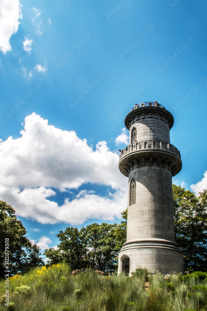gray stone tower in front of a blue sky gray stone tower in front of a blue sky