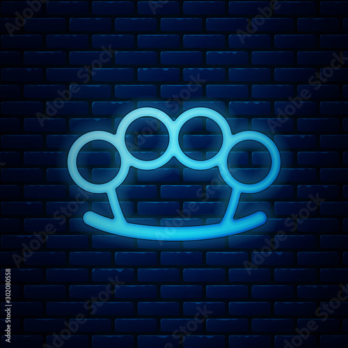 Glowing neon Brass knuckles icon isolated on brick wall background. Vector Illustration