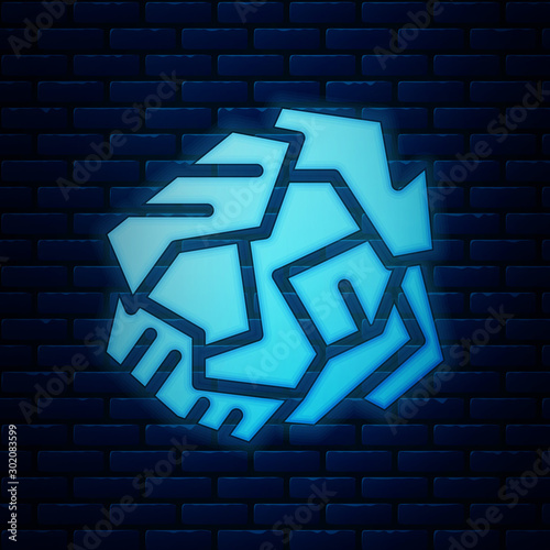 Glowing neon Crumpled paper ball icon isolated on brick wall background. Vector Illustration