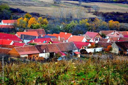 Typical rural landscape and peasant houses in Garbova, Transylvania, Romania. The settlement was founded by the Saxon colonists in the middle of the 12th century photo