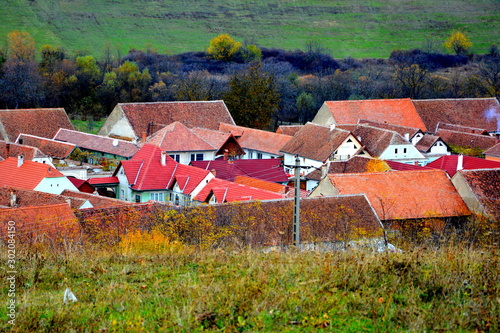 Typical rural landscape and peasant houses in Garbova, Transylvania, Romania. The settlement was founded by the Saxon colonists in the middle of the 12th century photo