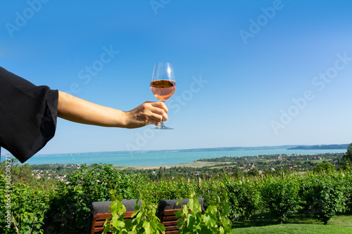 06.08.2019. - Csopak, Hungary: Drining rose wine over Lake Balaton in Csopak Hungary