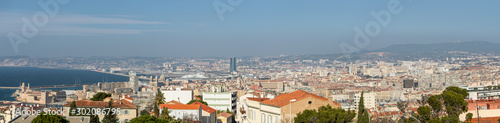 Panoramic bird view over modern center, port and suburbs in Marseille at sundown France, sunny day, blue sky