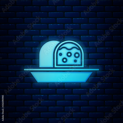 Glowing neon Marzipan sponge cake icon isolated on brick wall background. Merry Christmas and Happy New Year. Vector Illustration