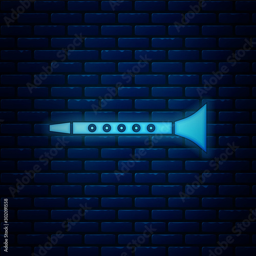 Glowing neon Clarinet icon isolated on brick wall background. Musical instrument. Vector Illustration