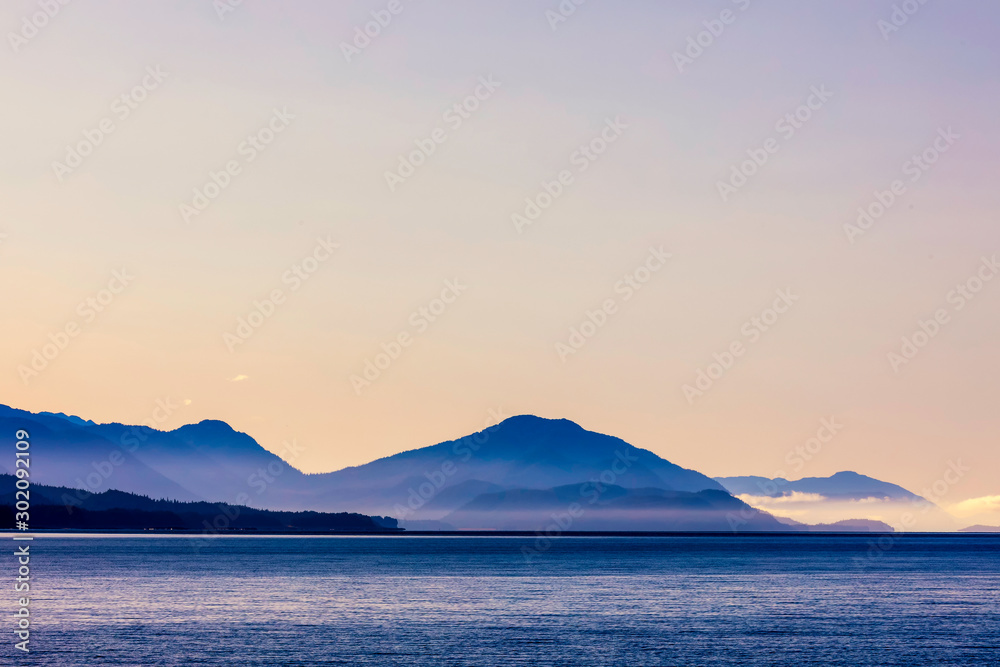 Pastel Sunset over Mountains and Ocean