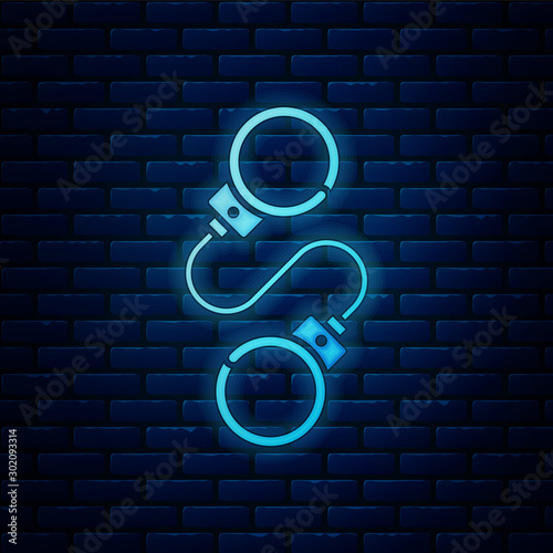 Glowing neon Handcuffs icon isolated on brick wall background. Vector Illustration
