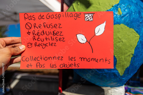Close up of french poster hand made by climate change activists at an ecological protest. Banner inviting the community to Recycle, reduce and reuse. photo