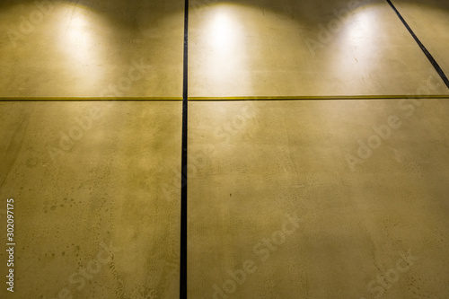 Polished concrete interior wall panels in diminishing perspective and dim light with copy spalce photo