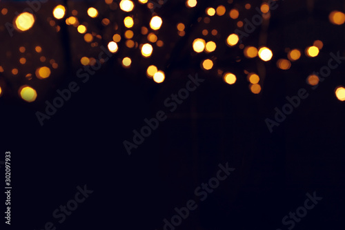 winter holidays Christmas post card concept wallpaper picture of golden bokeh from garland illumination on black background empty copy space for your text here  photo